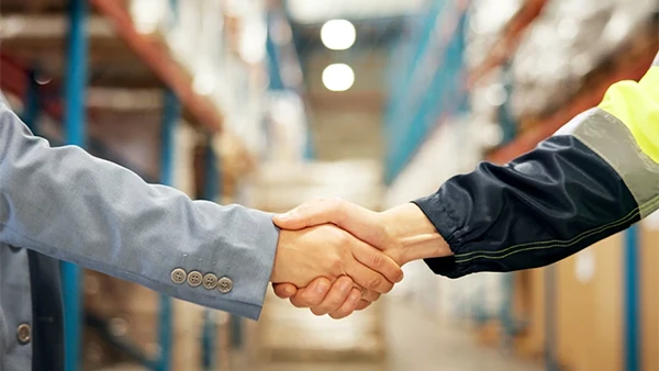 Stretta di mano con partner B2B per trasporti e logistica